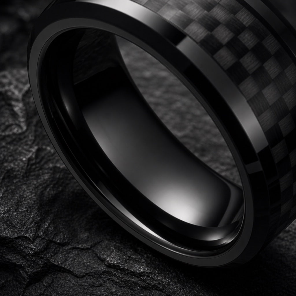 Agile ring angled on dark charcoal stone to show the polished blank black interior with carbon fibre exterior visible