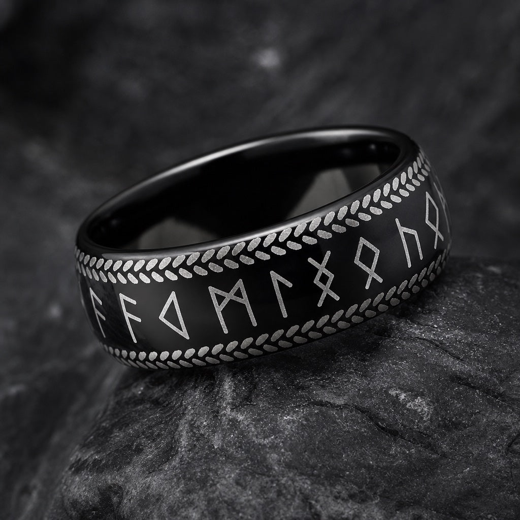Macro of the Berserker ring's silver Norse runes and braided borders on black tungsten