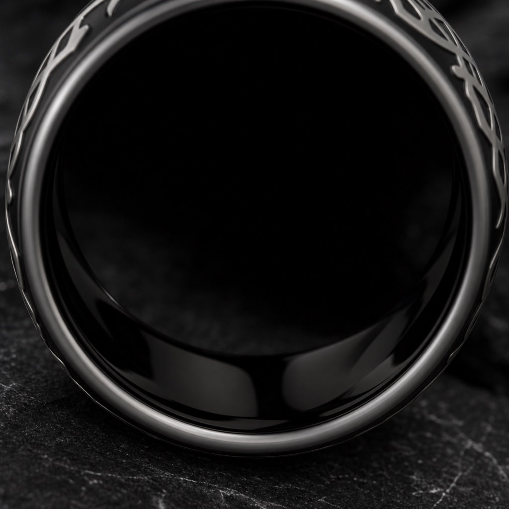 Drago ring angled to show the polished black interior of the band on dark stone