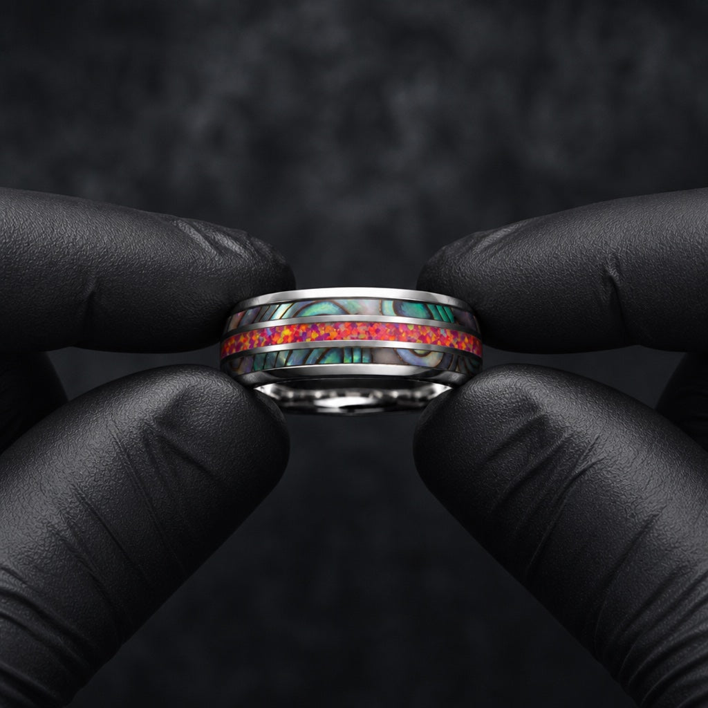 Gloved hands presenting the Firestone ring, comfort-fit silver interior and three-channel inlay visible