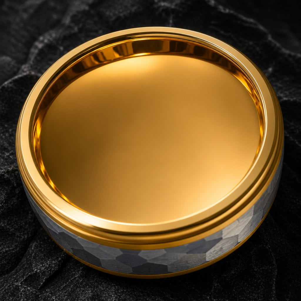 Lustre ring angled on dark charcoal stone to show the polished yellow-gold interior of the band