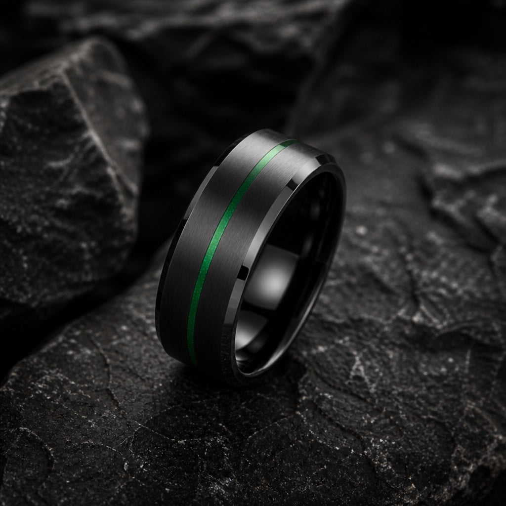 The Neo ring resting on dark charcoal rock, brushed black body, bevelled edges and centred green line readable