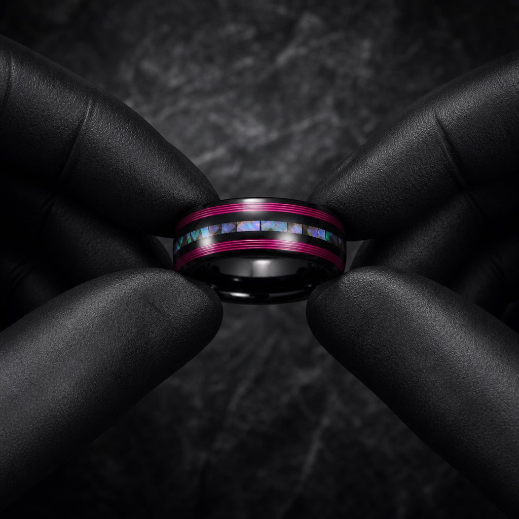 Gloved hands presenting the Neon ring, comfort-fit black interior, neon pink rails and abalone visible