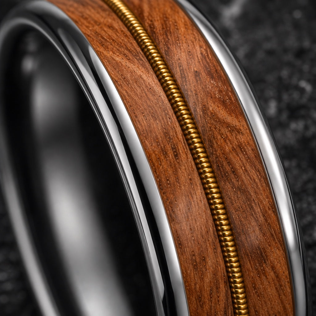 Macro of the Sharp ring whiskey-barrel oak inlay and gold guitar-string wire on dark charcoal stone