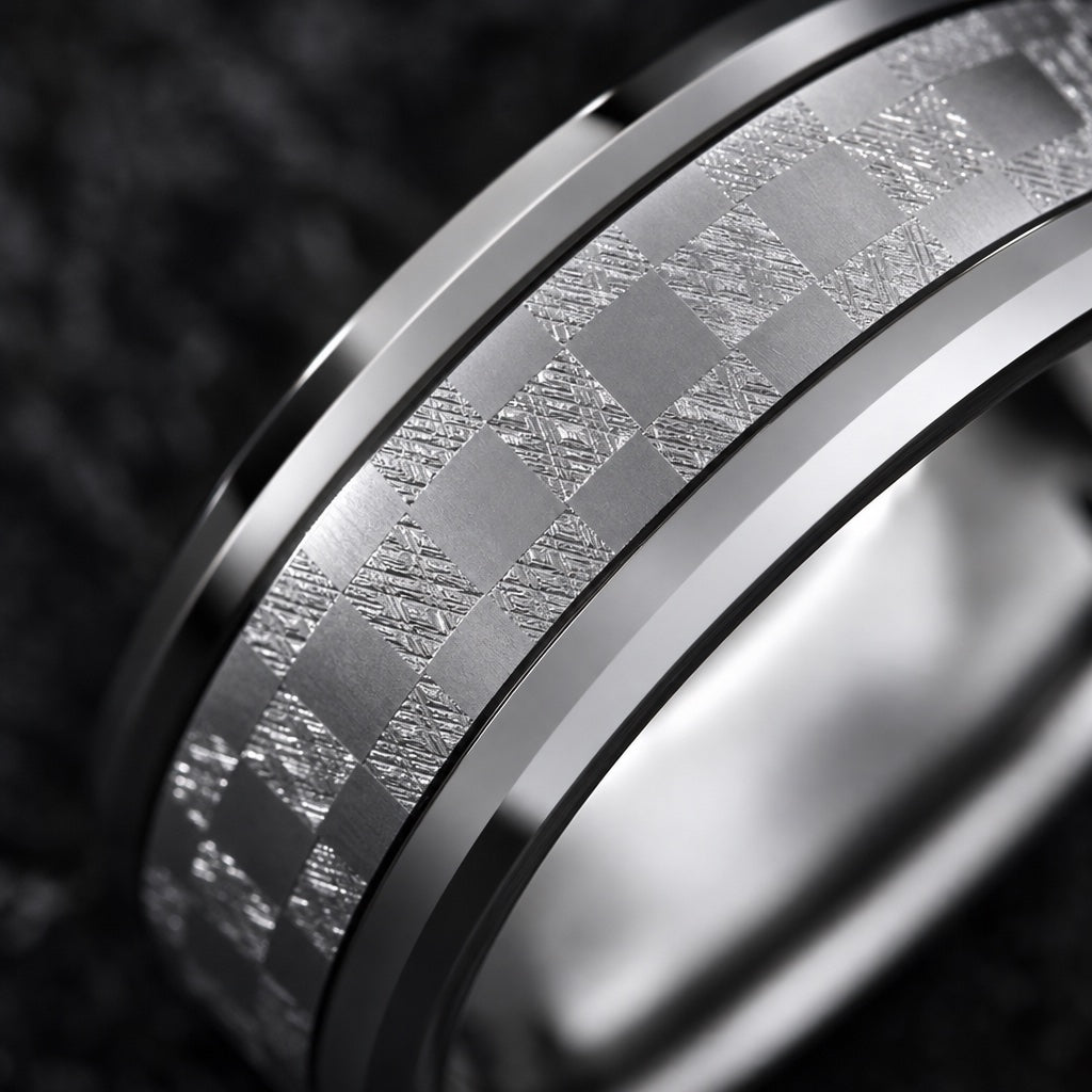 Macro of the Shimmer ring's centred checkered mosaic silver shimmer channel between polished bevels on dark charcoal stone