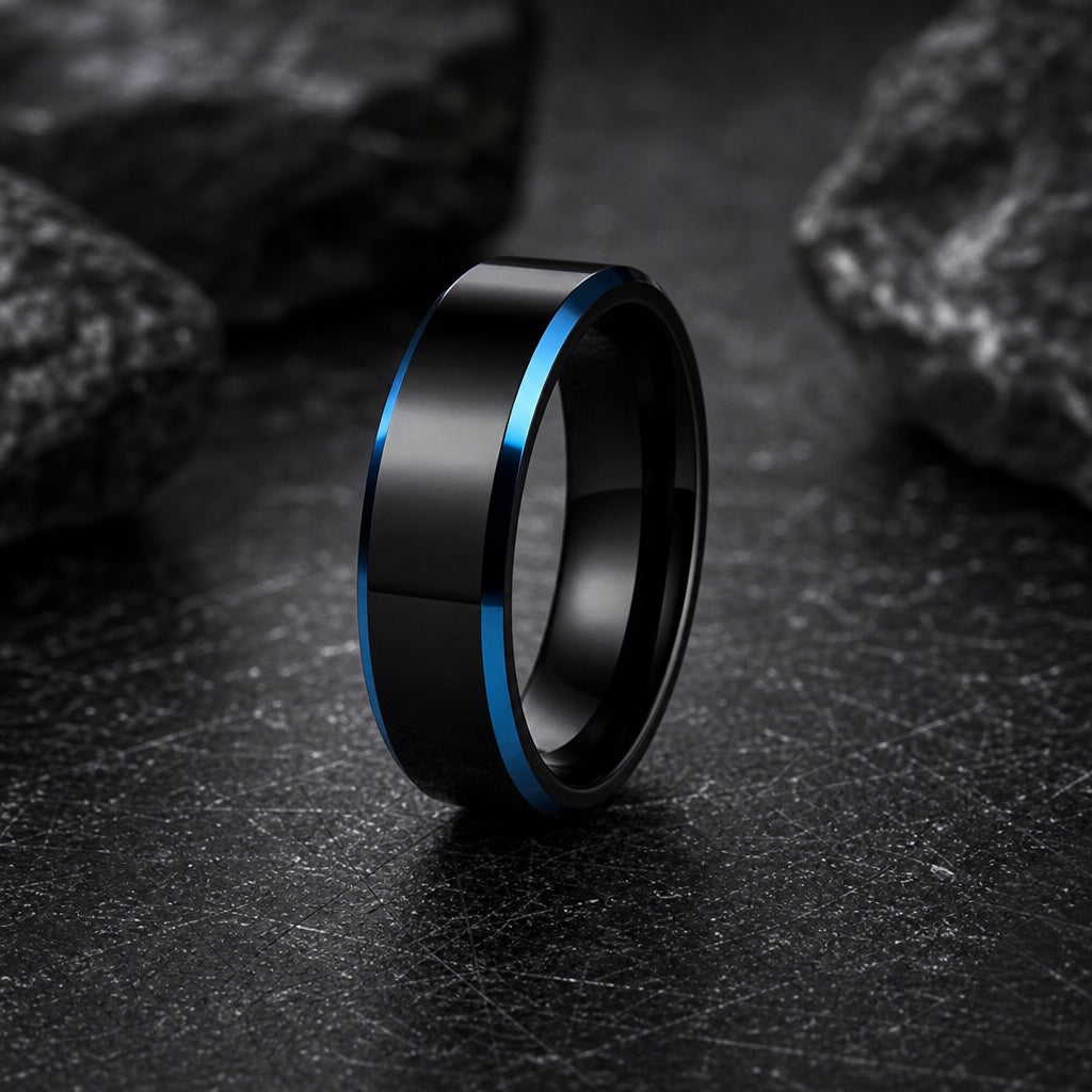 Shock ring showing electric blue bevelled edges against the polished black face on dark charcoal stone