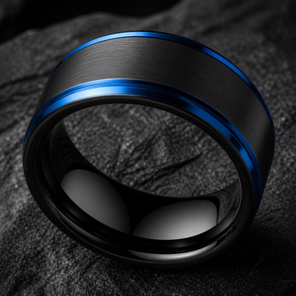 Subzero ring angled on dark charcoal stone filling the frame with blank polished black interior, electric-blue stepped rails visible only at the rim