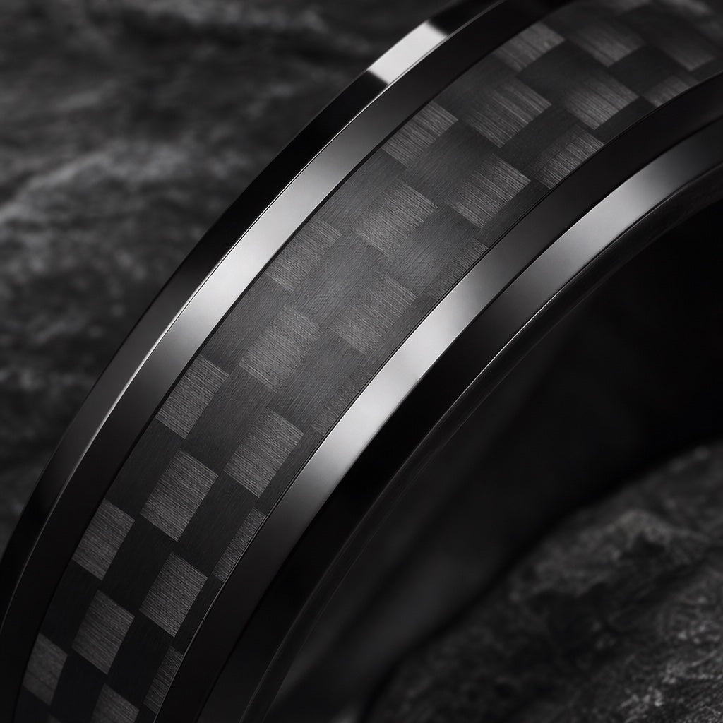 Macro of the Turbo ring's centred carbon-fibre weave channel on polished black bevels against dark charcoal stone