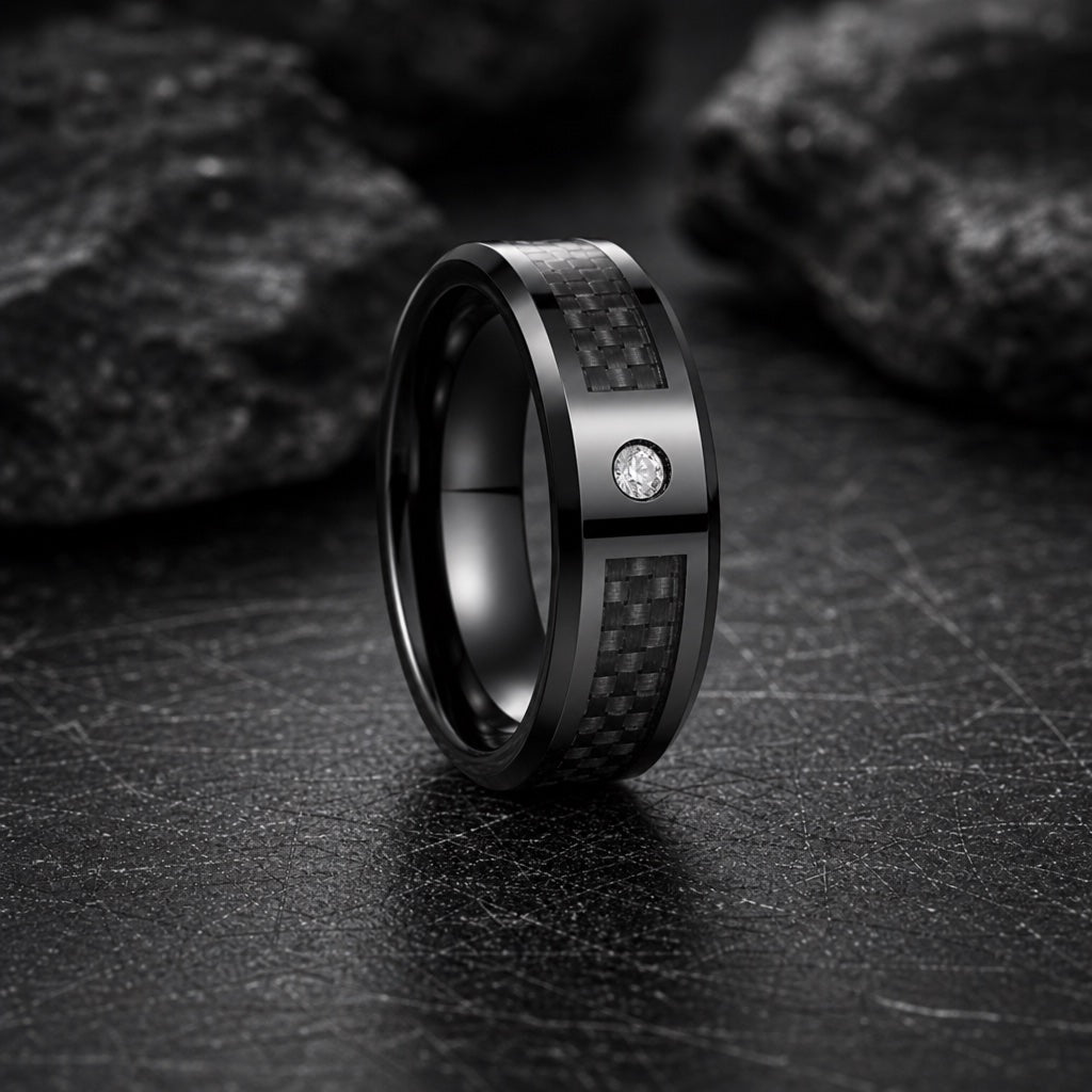 Agile ring profile showing polished bevelled edges framing the centred carbon fibre inlay on dark charcoal stone