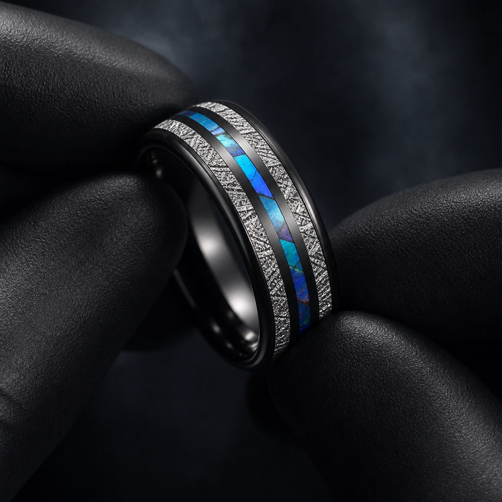 Gloved hands presenting the Andromeda ring, comfort-fit curve visible