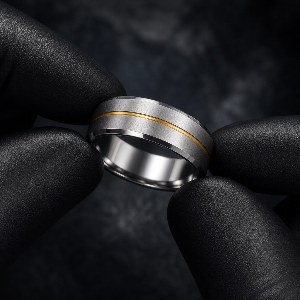 Gloved hands presenting the Beam ring, gold centre stripe, polished bevels, and comfort-fit curve visible