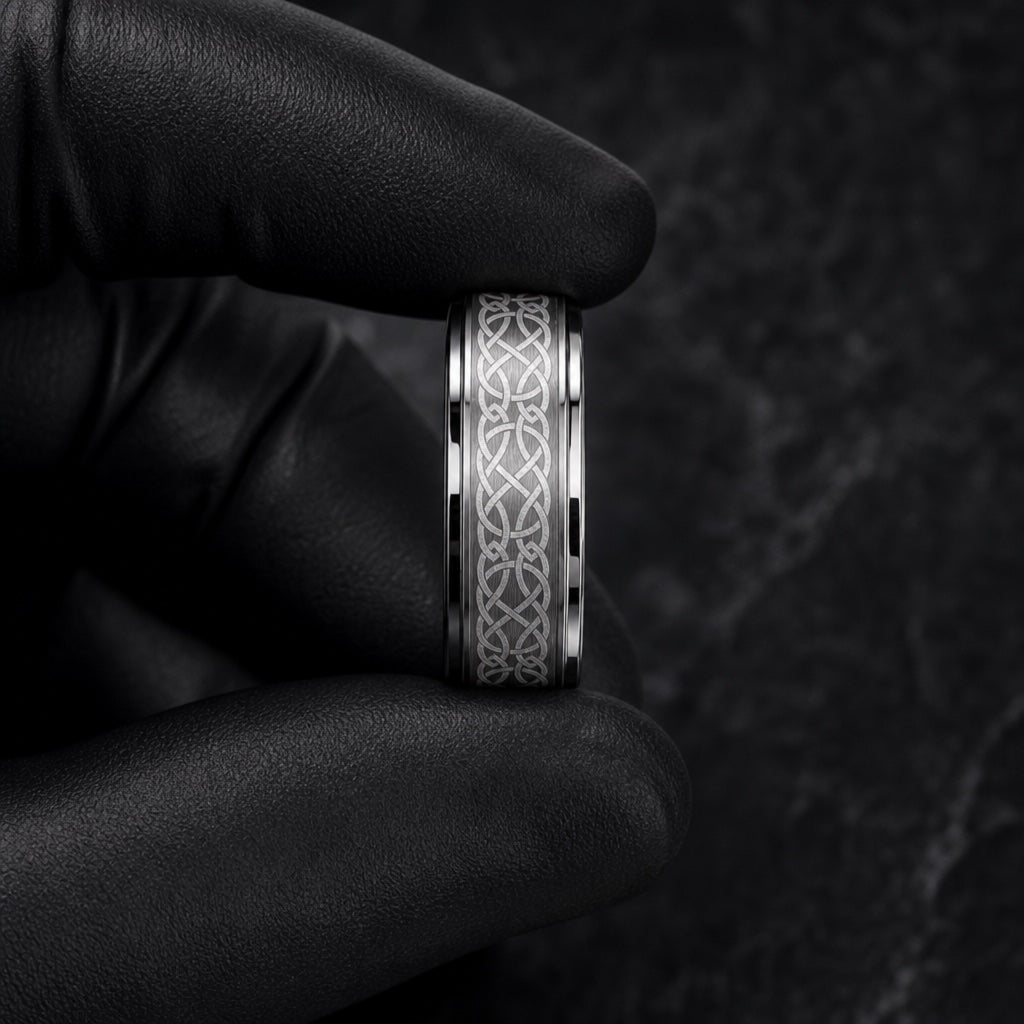 Gloved hands presenting the Celtic ring, comfort-fit curve and knot face visible