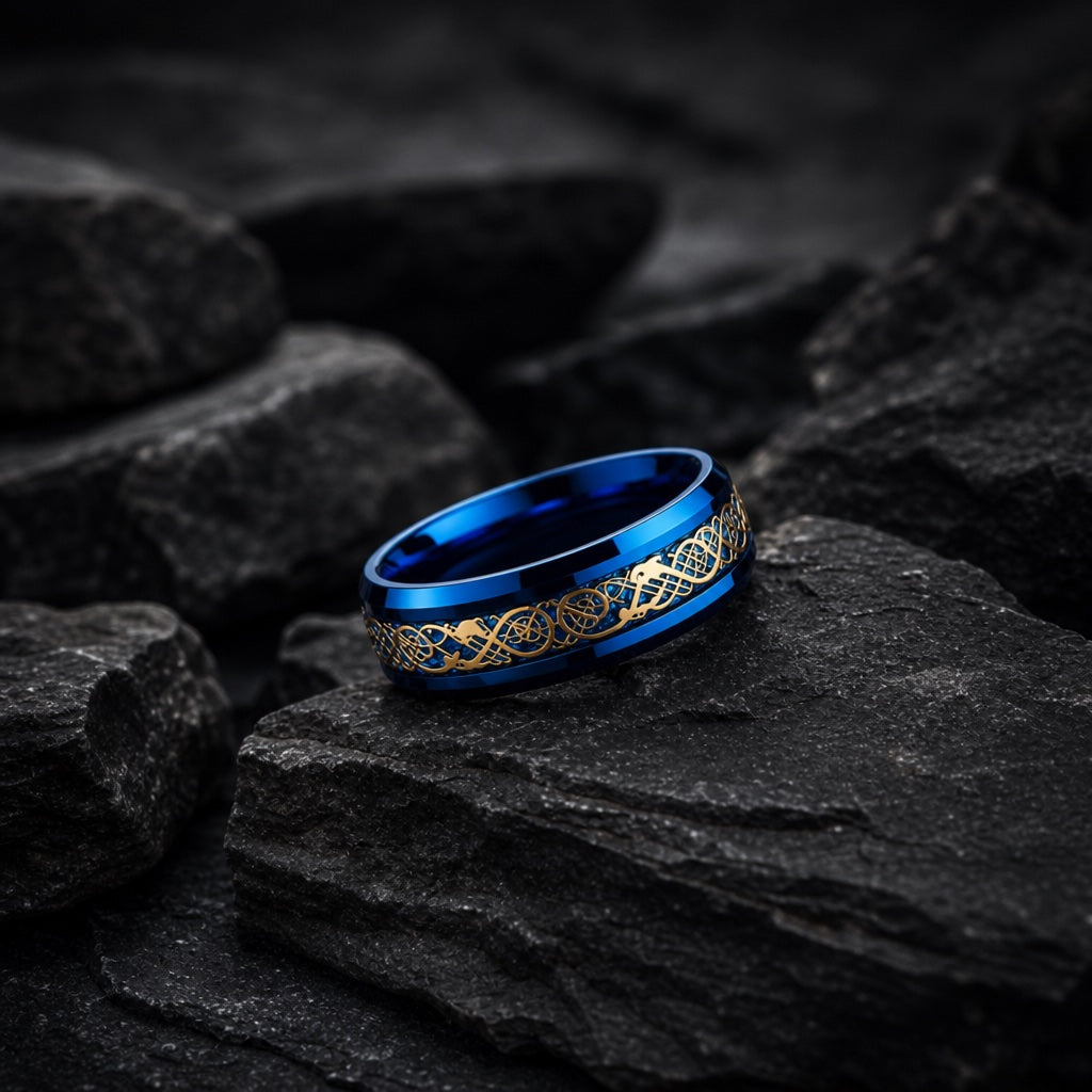 The Hydra ring resting against dark rock, electric blue body and gold filigree visible