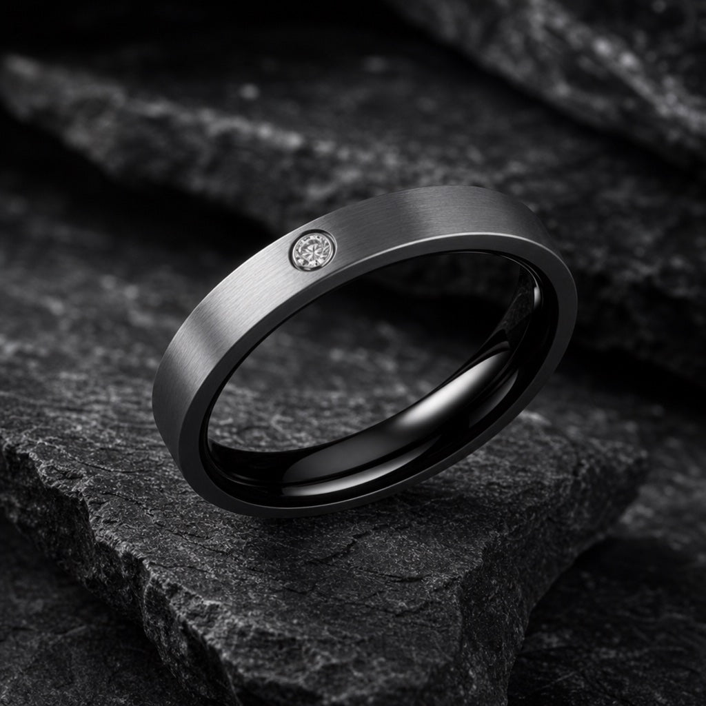 Ice ring angled on dark charcoal stone showing the polished black blank interior