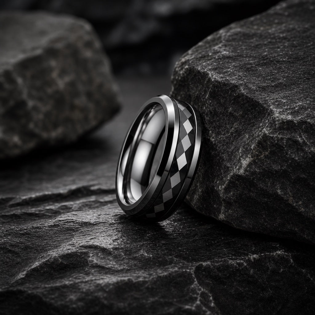 The Immortal ring resting against dark rock, polished black body and harlequin channel visible