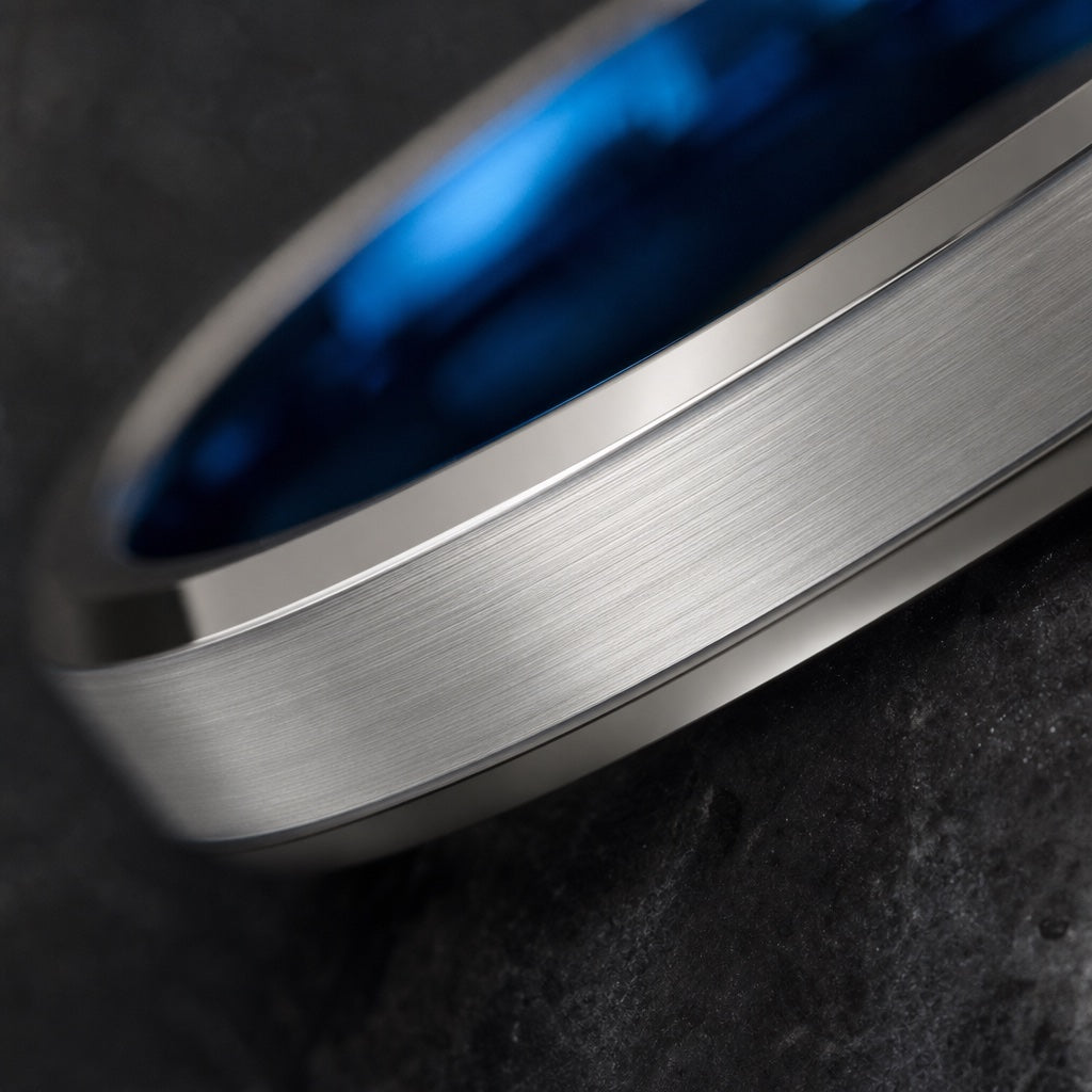 Macro of the Jolt ring's brushed silver face on dark charcoal stone