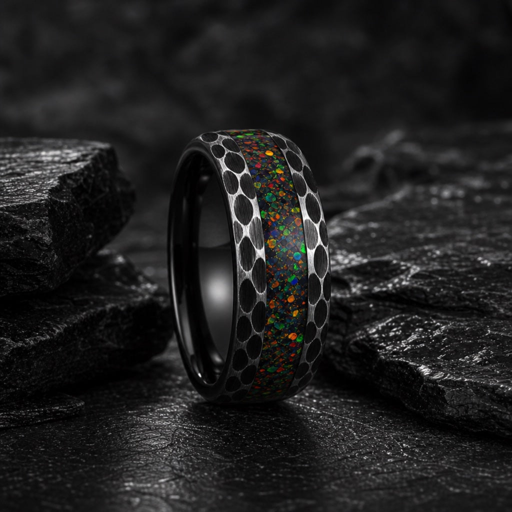Prime ring showing hammered dimpled black tungsten flanks beside the centred opal channel