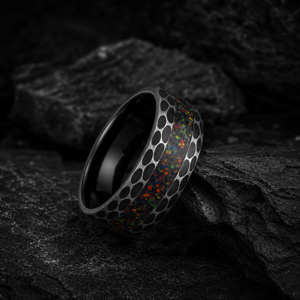 Prime ring full band against dark charcoal rock with centred opal and hammered black flanks