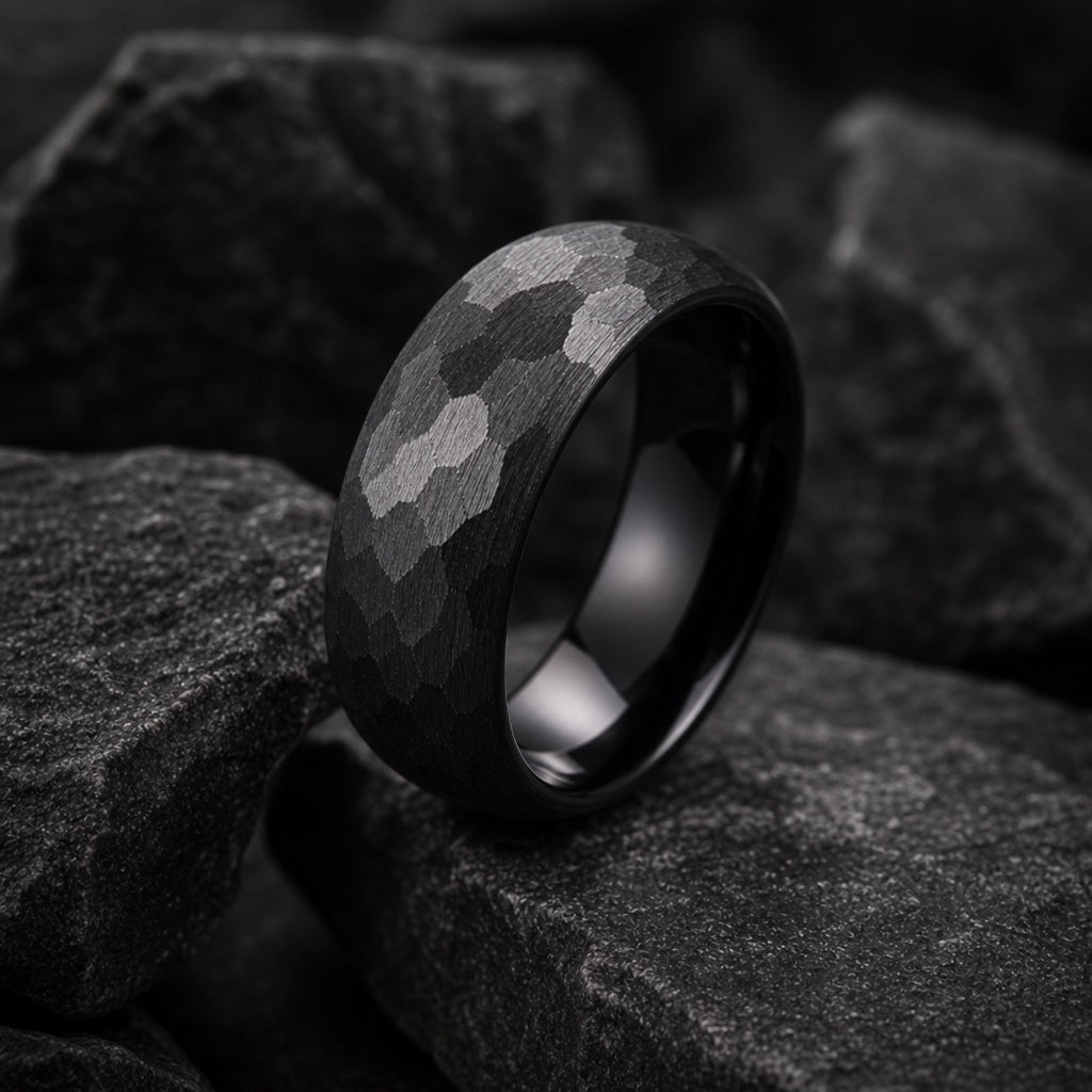 Rugged ring angled to show the soft round domed outer edge and hammered matte black face on dark stone