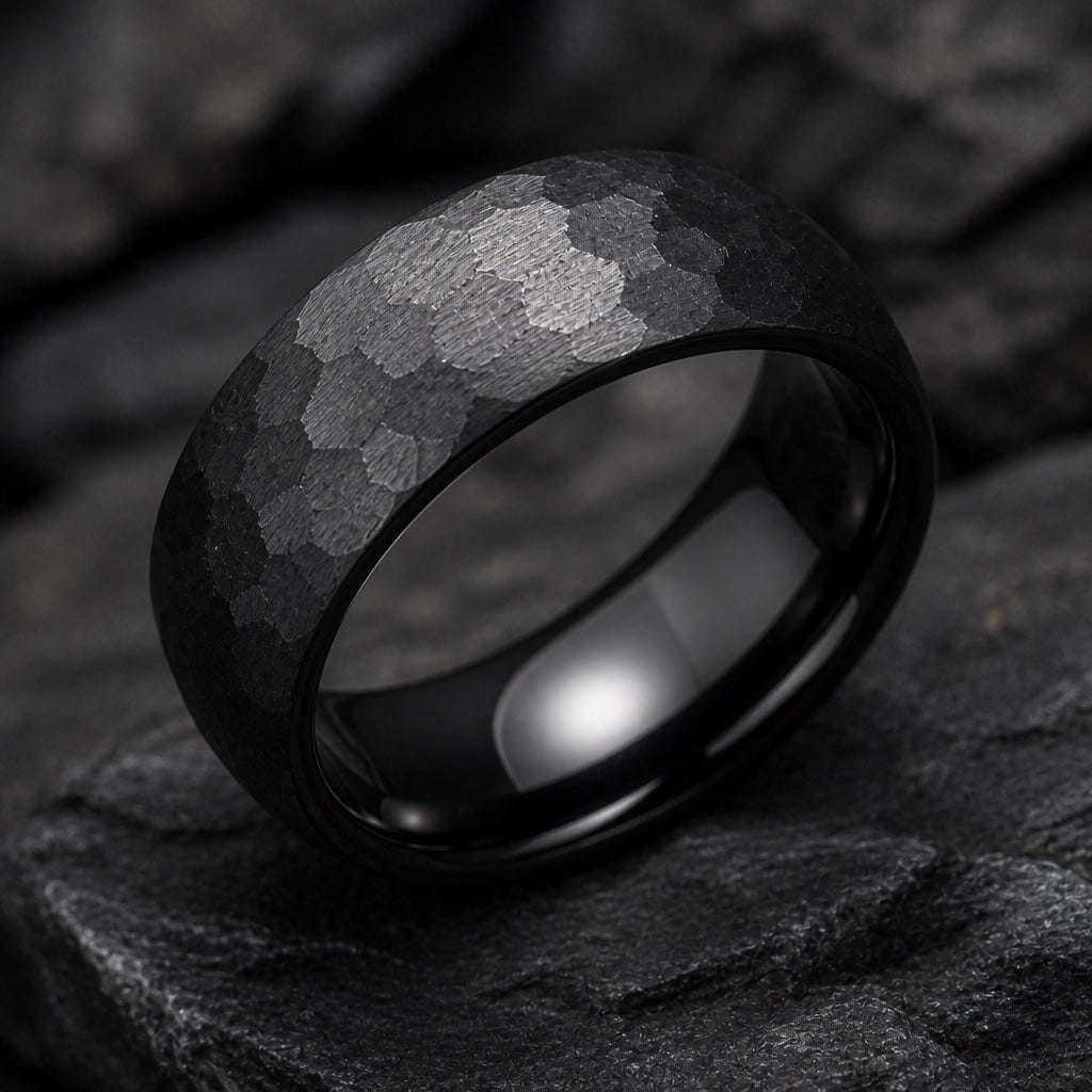 Rugged ring angled on dark charcoal stone so the polished black blank interior fills most of the frame