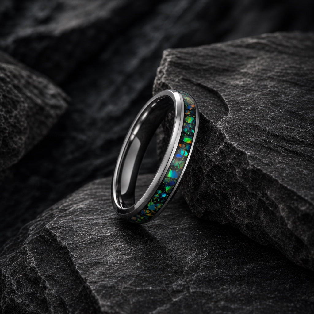 Saint ring full band on dark charcoal rock with abalone and opal channel visible