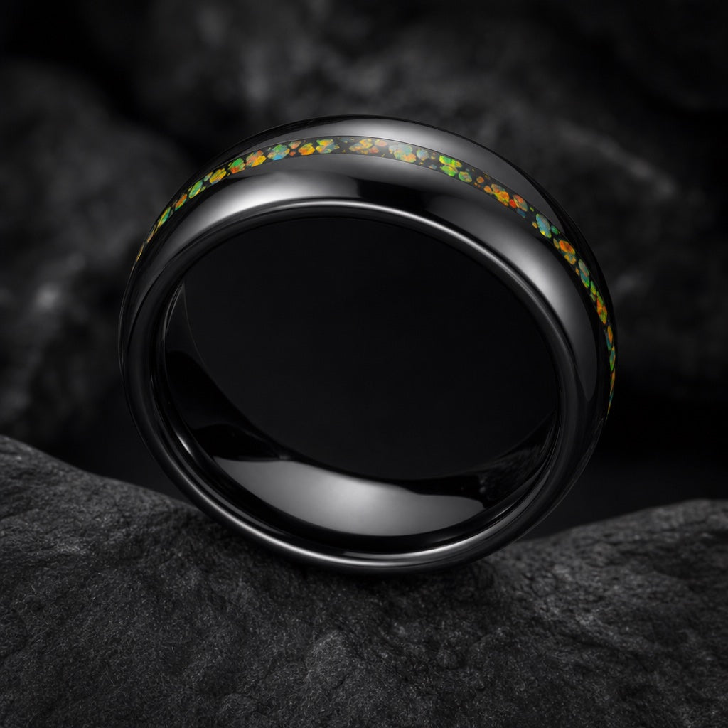 Seraph ring angled on dark charcoal stone to show the blank polished black interior of the band