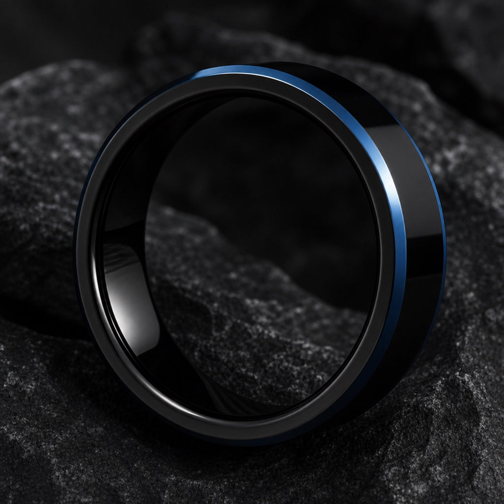Shock ring angled on dark charcoal stone showing the blank polished black interior of the band