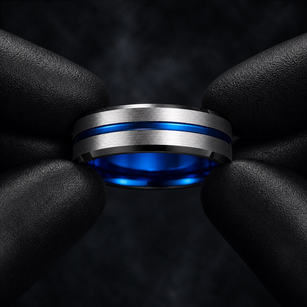 Gloved hands presenting the Sublime ring, electric-blue interior, thin blue groove, and comfort-fit curve visible