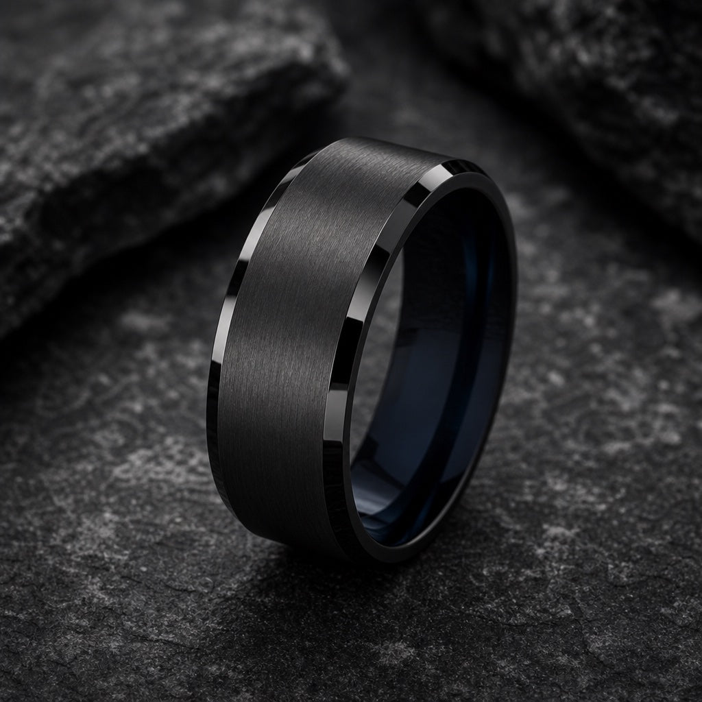 Tempest ring showing polished black bevelled outer rails against the brushed charcoal face