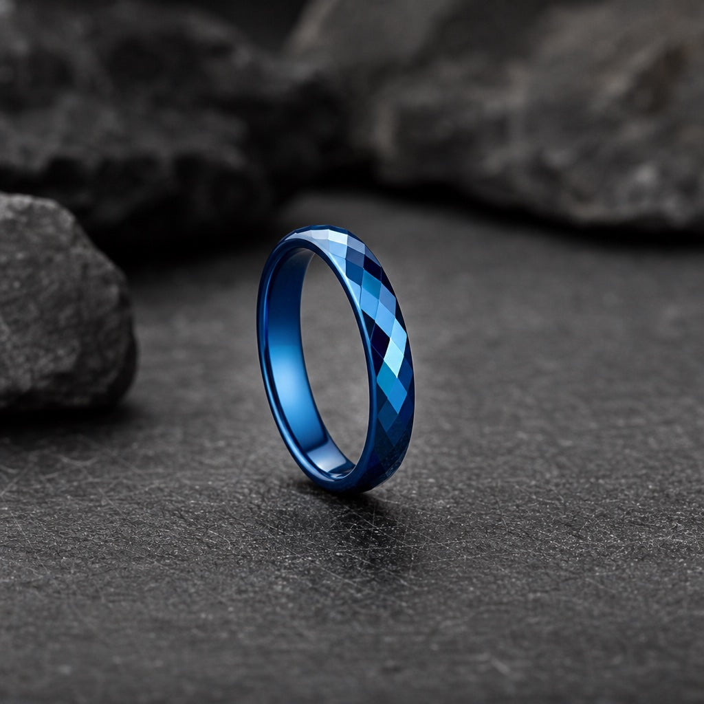 Virtue ring standing on dark stone showing slim 4mm round faceted electric-blue profile