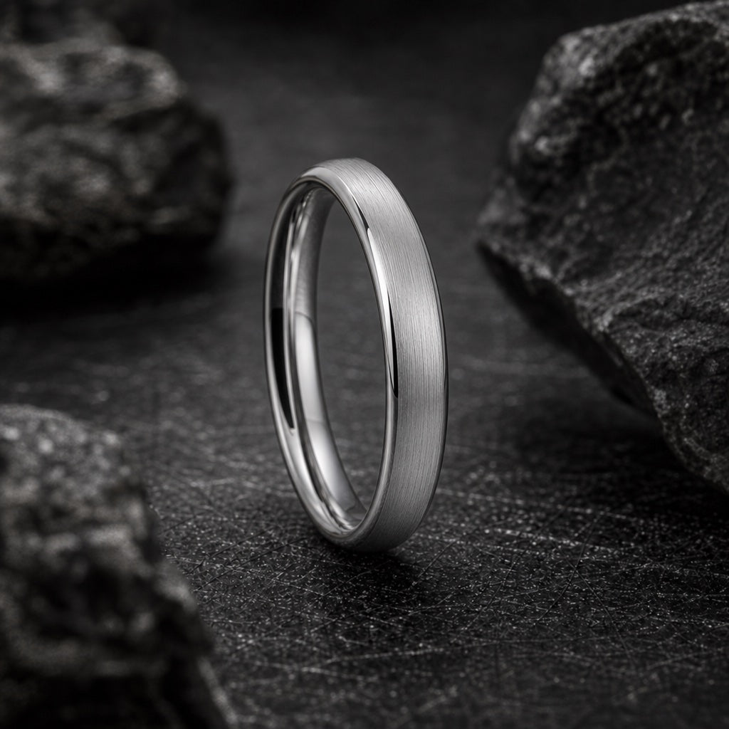 Wisp ring showing true 4mm round soft-domed outer profile against dark charcoal stone